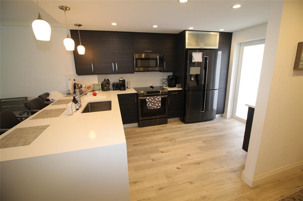 750 North Ocean Boulevard, Unit 1610 Pompano Beach, FL 33062 - Photo 6 of 17 a kitchen with stainless steel appliances kitchen island granite countertop a refrigerator a stove a sink a oven and a refrigerator