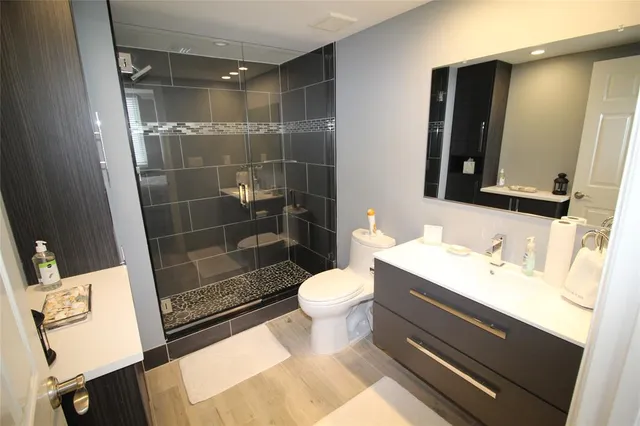 a bathroom with a sink toilet and shower