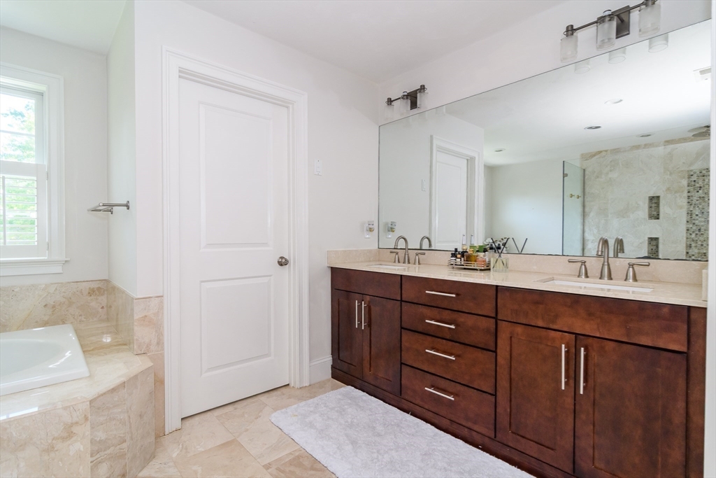 2 Hunters Lane Natick, MA 01760 - Photo 19 of 40 a bathroom with a sink double vanity granite tub shower and a mirror