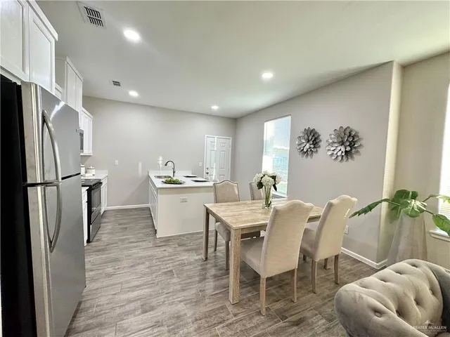 a kitchen with appliances cabinets and furniture