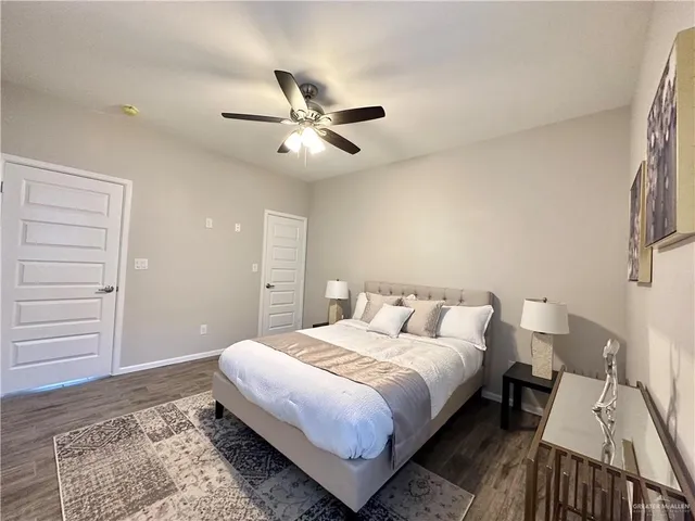 a bedroom with a bed rug and dresser