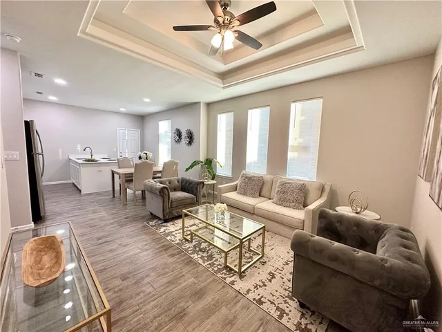 a living room with lots of furniture and a chandelier