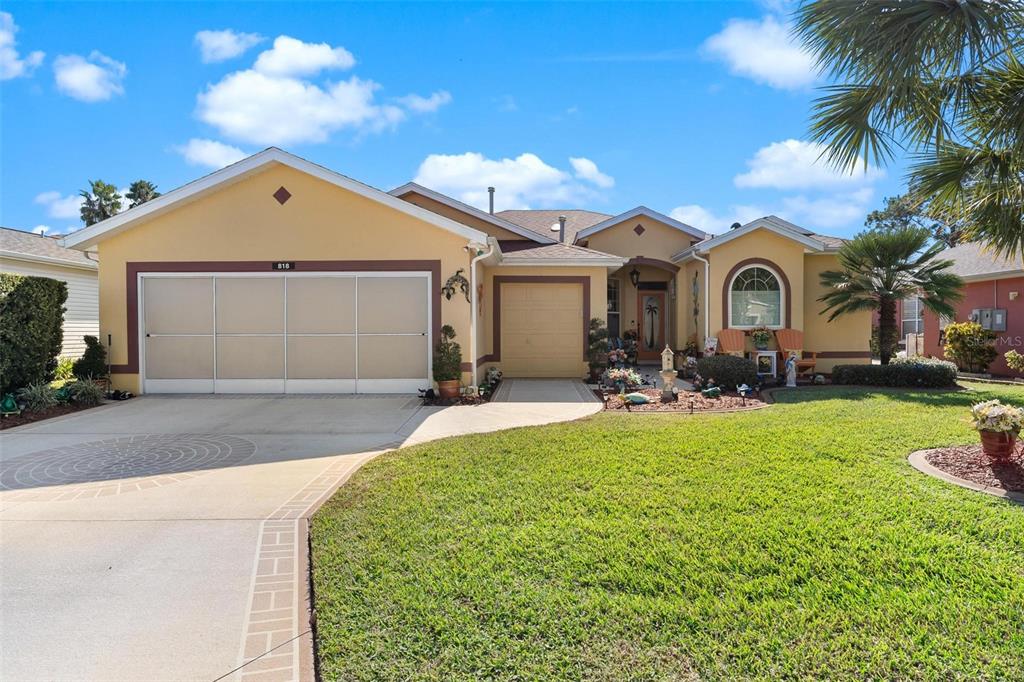 818 Forest Breeze Path Leesburg, FL 34748 - Photo 1 of 1 a front view of a house with a yard and garage