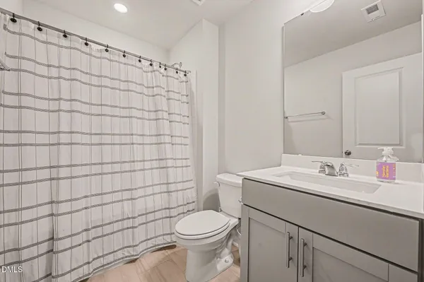 a kitchen with stainless steel appliances kitchen island granite countertop a refrigerator a stove and a sink with wooden floor