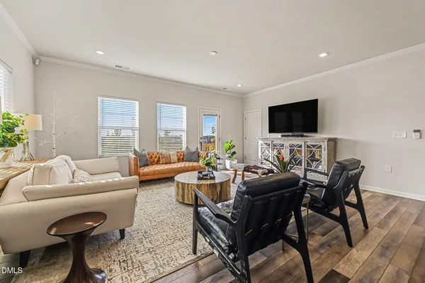 a kitchen with kitchen island granite countertop a sink a stove oven a counter top space and cabinets