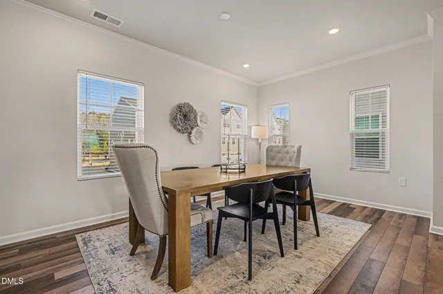 a living room with furniture a flat screen tv and a window