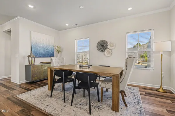 a living room with furniture a flat screen tv and a window