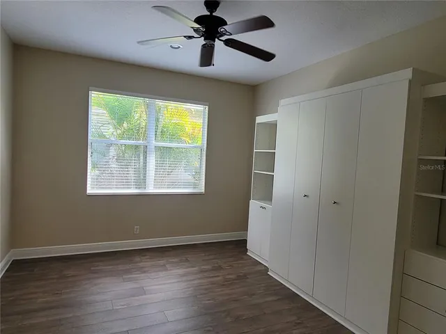a bathroom with a bathtub shower sink vanity mirror and toilet
