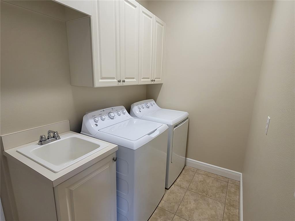 7486 Edenmore Street Lakewood Ranch, FL 34202 - Photo 23 of 28 a utility room with dryer and washer