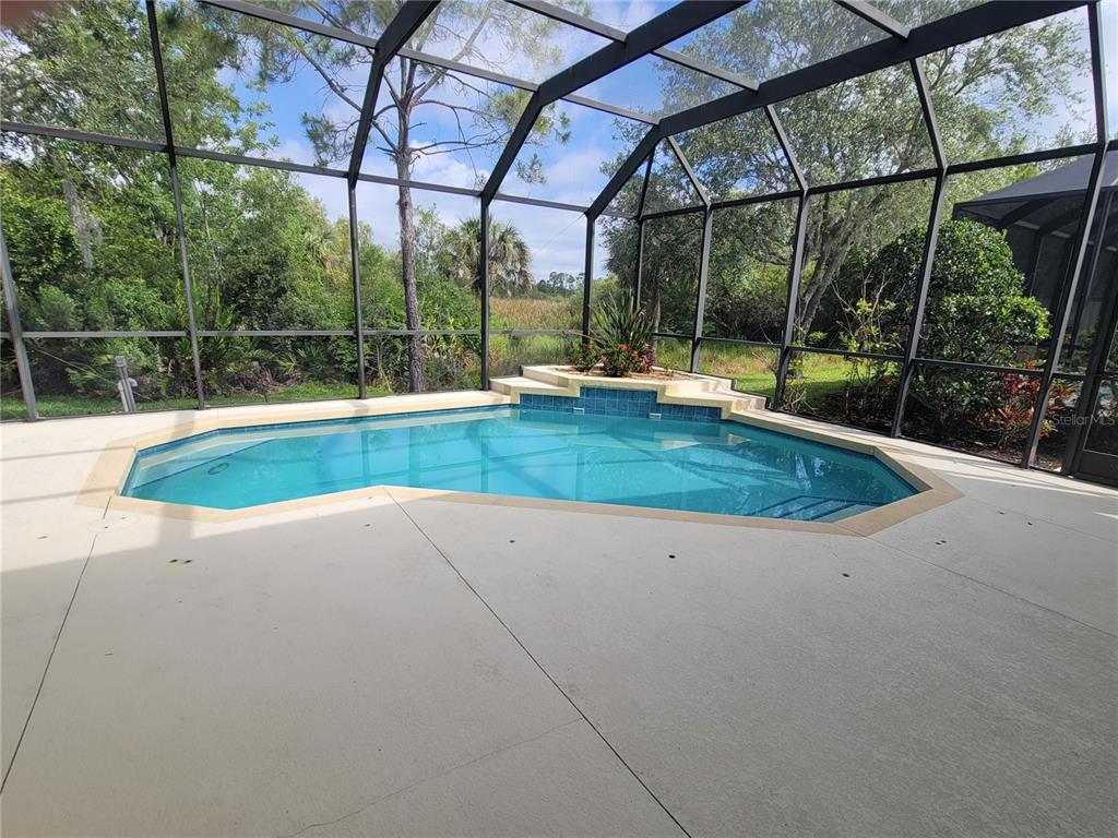 7486 Edenmore Street Lakewood Ranch, FL 34202 - Photo 25 of 28 a view of white house with a swimming pool