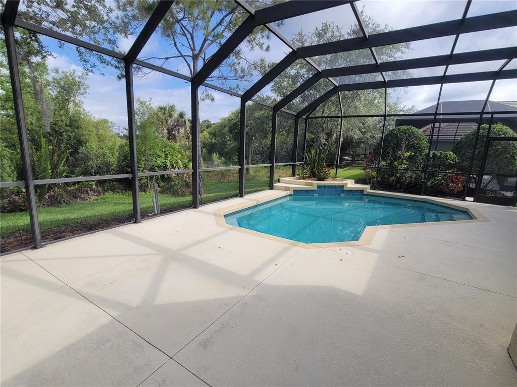 7486 Edenmore Street Lakewood Ranch, FL 34202 - Photo 26 of 28 a view of a backyard with porch and a patio