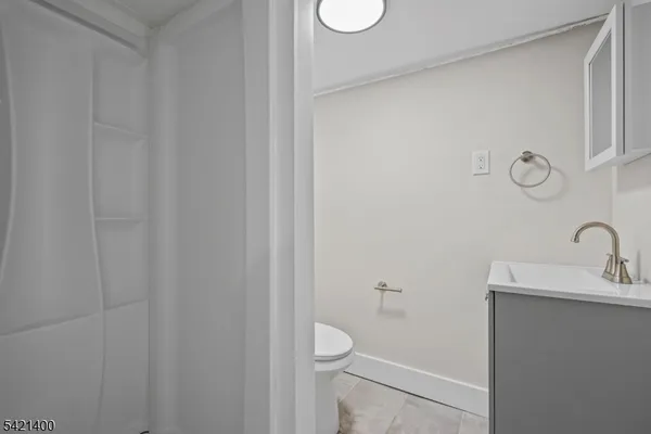 a bathroom with a sink a toilet and a mirror