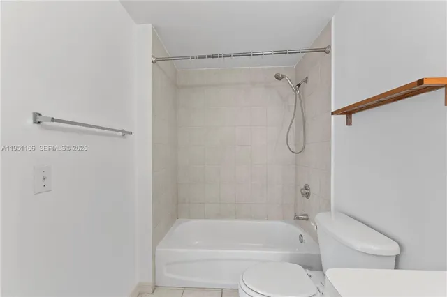 a bathroom with a shower and a toilet