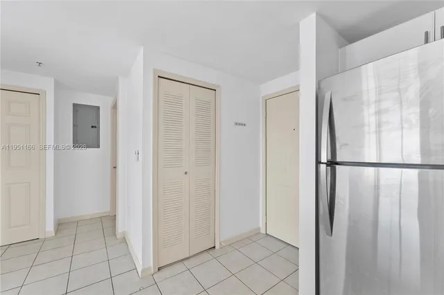 a view of a kitchen with a refrigerator and cabinets