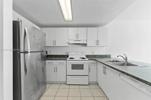 a kitchen with a stove sink and refrigerator