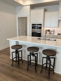 3472 Fishpond Circle Dacula, GA 30019 - Photo 17 of 72 a kitchen with granite countertop a table chairs stove and cabinets