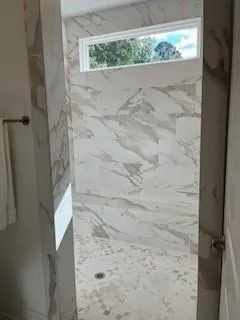 an aerial view of residential houses with outdoor space and lake view