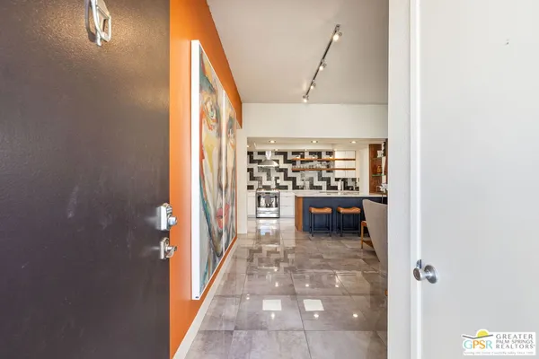 a view of a hallway and a livingroom with furniture