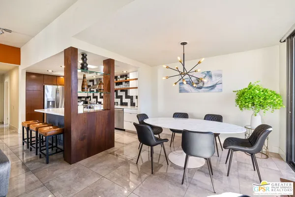 a view of a dining room with furniture and chandelier
