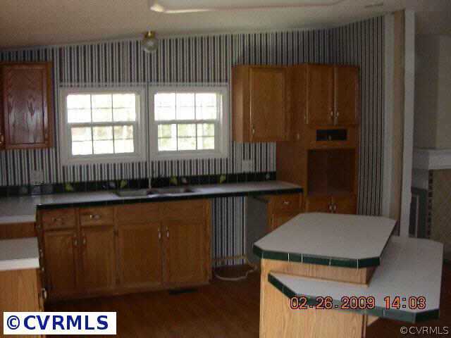 3620 Shirleys Hill Road Partlow, VA 22534 - Photo 5 of 6 a kitchen with a refrigerator and a stove top oven