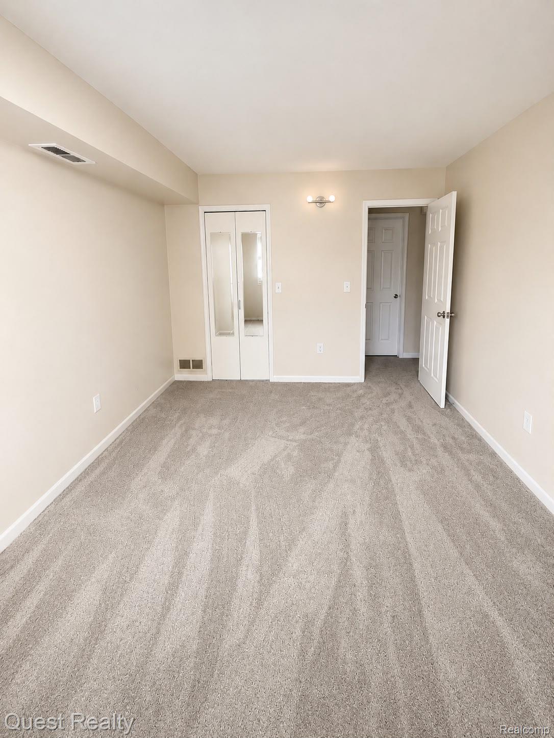 30028 West 12 Mile Road Farmington, MI 48334 - Photo 8 of 13 Neutral-toned wall paint and matching carpet flooring define this interior space