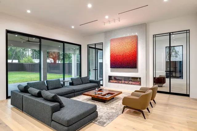 a living room with furniture and large window