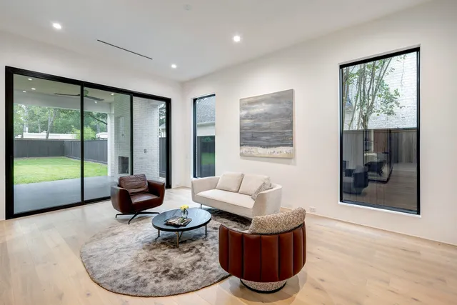 a living room with furniture and a floor to ceiling window