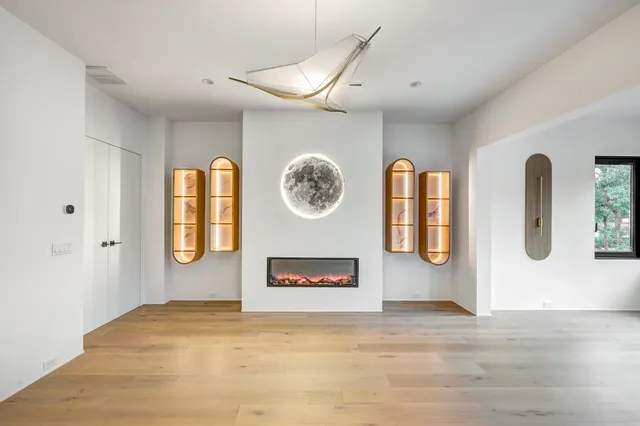 a view of a livingroom with furniture wooden floor and a ceiling fan