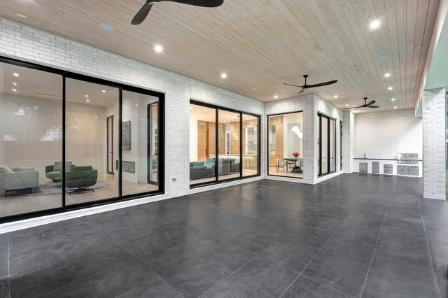 a hallway with wooden floor and windows