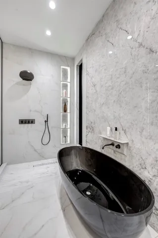 a view of an empty room with a fireplace and potted plants