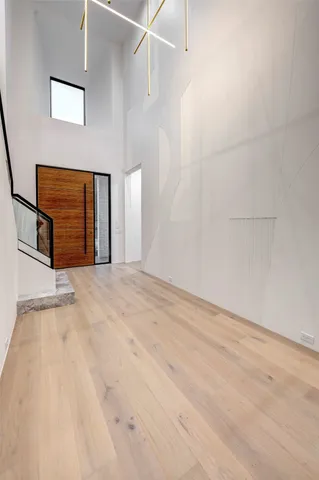 a view of a livingroom with wooden floor and a ceiling fan