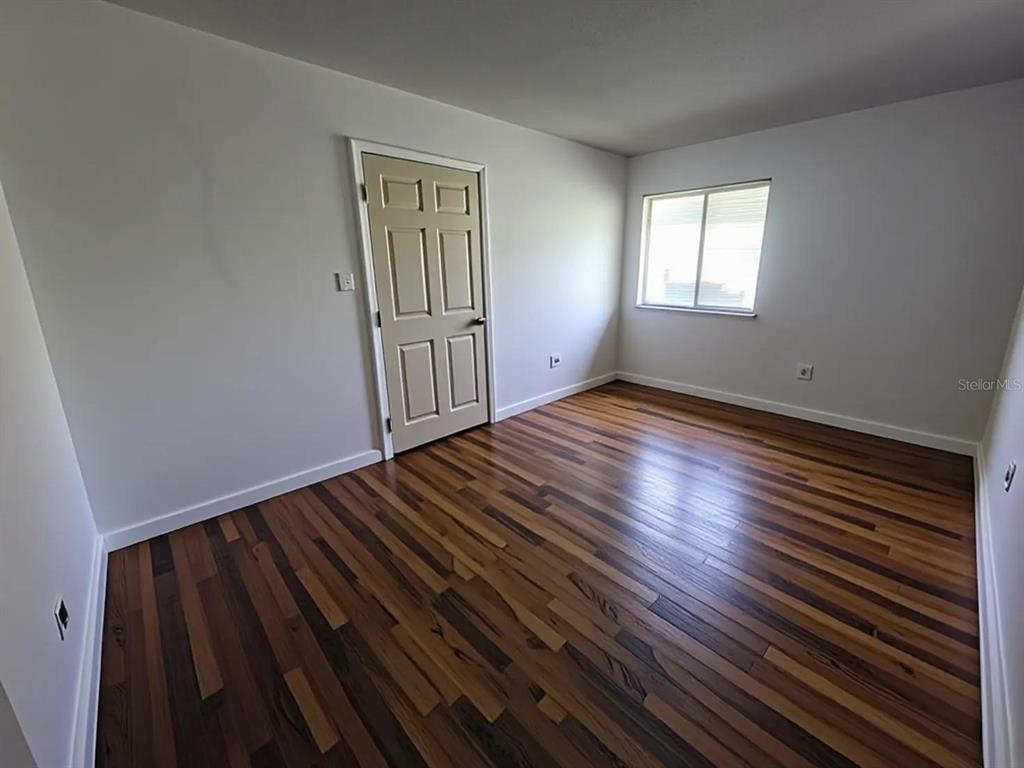 626 Fairways Circle, Unit A Ocala, FL 34472 - Photo 14 of 21 a view of an empty room with wooden floor and a window