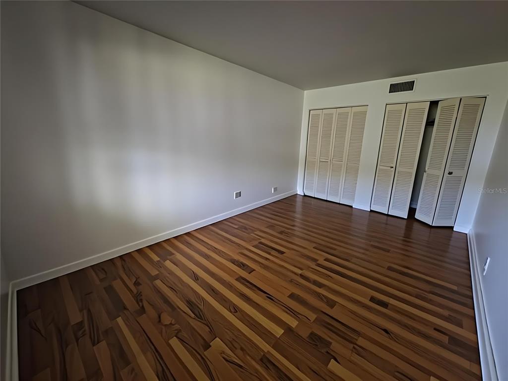 626 Fairways Circle, Unit A Ocala, FL 34472 - Photo 15 of 21 an empty room with wooden floor