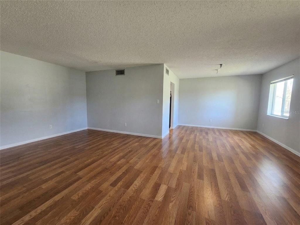 626 Fairways Circle, Unit A Ocala, FL 34472 - Photo 17 of 21 a view of empty room with wooden floor