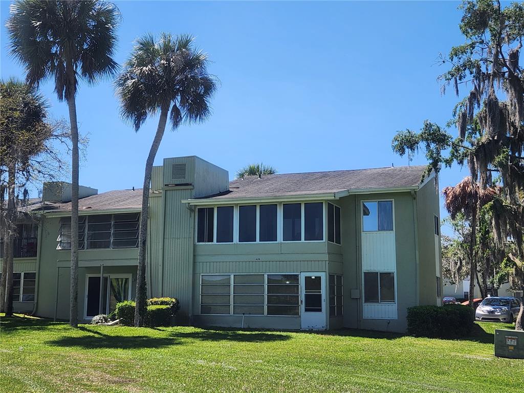 626 Fairways Circle, Unit A Ocala, FL 34472 - Photo 19 of 21 a front view of a house with a yard