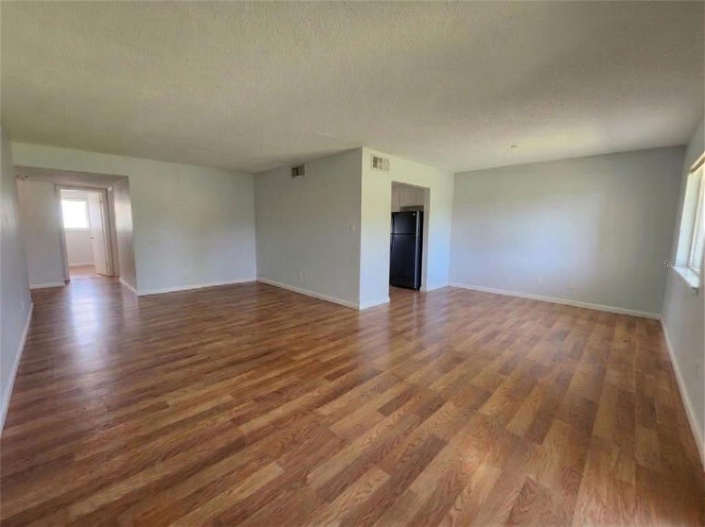 626 Fairways Circle, Unit A Ocala, FL 34472 - Photo 4 of 21 a view of an empty room and wooden floor