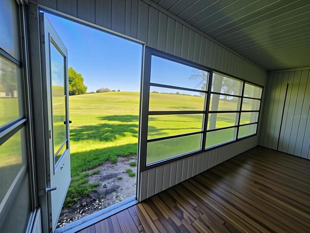 626 Fairways Circle, Unit A Ocala, FL 34472 - Photo 6 of 21 a view of a balcony with floor to ceiling windows with wooden floor
