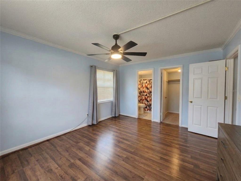 626 Fairways Circle, Unit A Ocala, FL 34472 - Photo 8 of 21 an empty room with wooden floor and ceiling fan