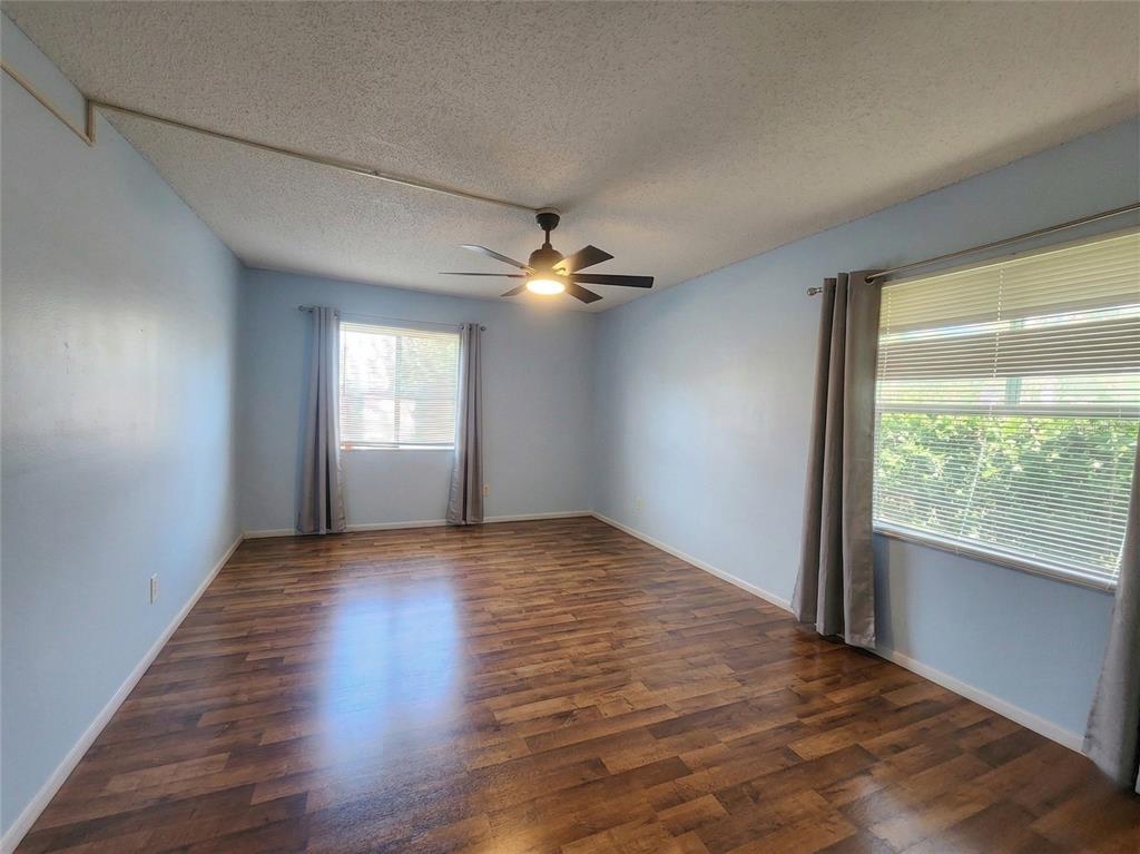 626 Fairways Circle, Unit A Ocala, FL 34472 - Photo 9 of 21 a view of an empty room with wooden floor and a window