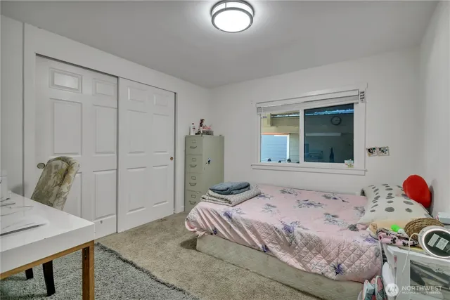 a bedroom with a bed and a table