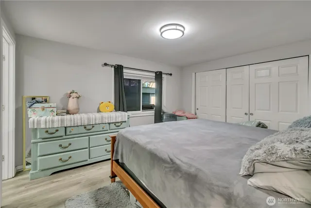 a bedroom with a bed and a dresser