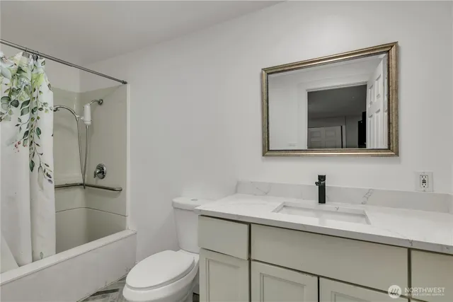 a bathroom with a toilet a sink and mirror
