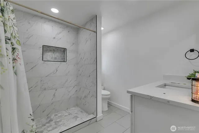 a bathroom with a shower sink and mirror