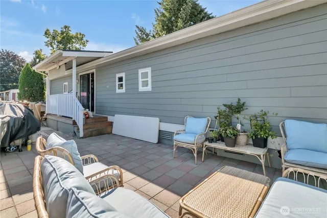 a view of a patio with couches table and chairs and potted plants