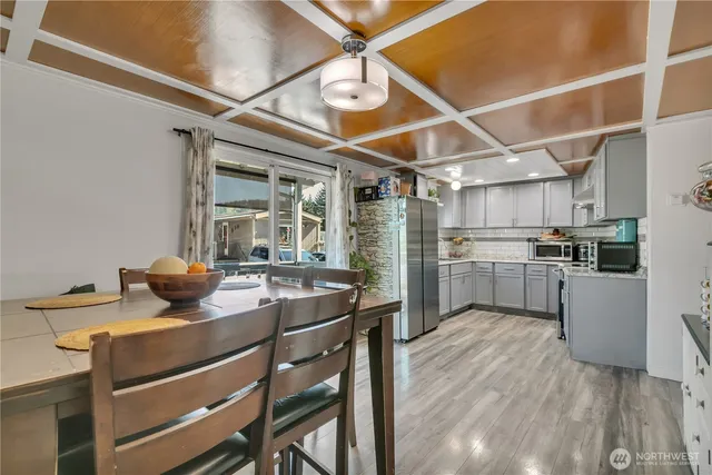 a kitchen with a sink stainless steel appliances and white cabinets