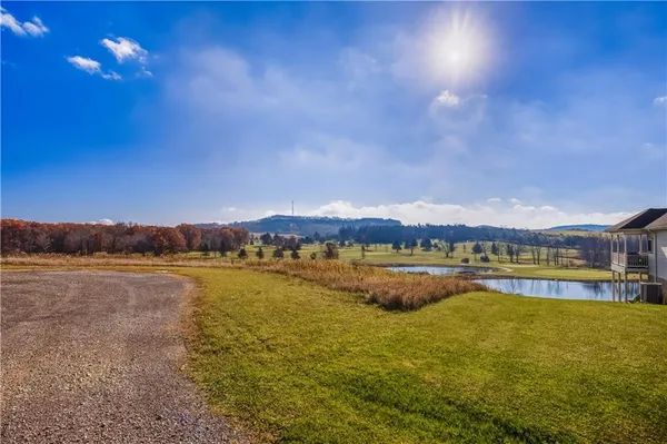 a view of a lake with houses in the back