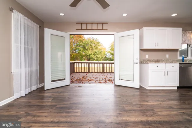 a view of kitchen with wooden floor and electronic appliances