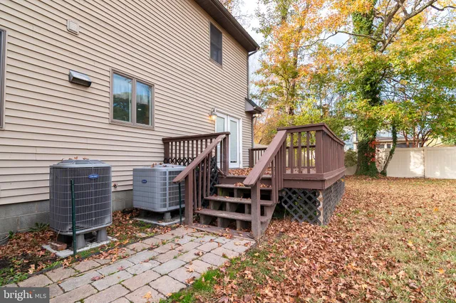 a backyard of a house with barbeque oven and bench