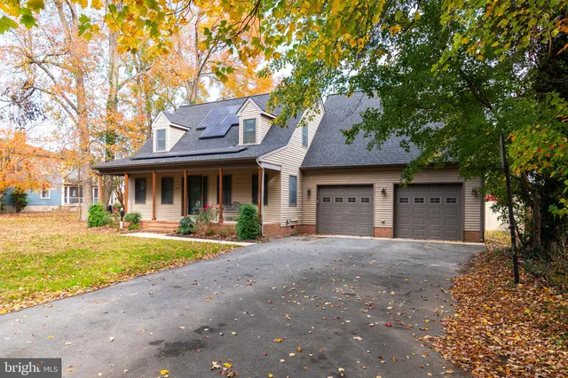 a front view of a house with a garden and patio