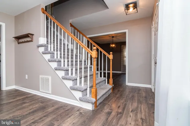 a view of entryway and hall with wooden floor